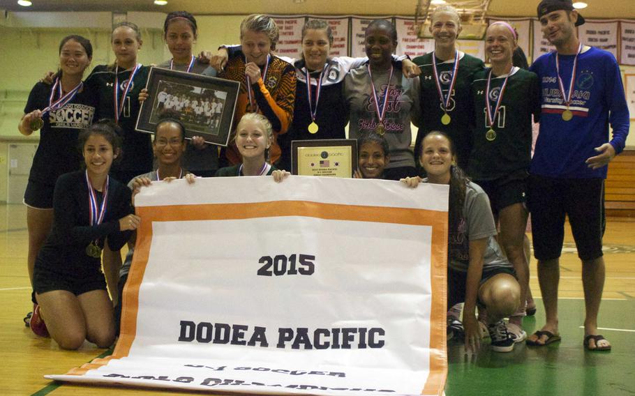 Banner time! Kubasaki's girls gather around the banner and display their championship hardware.