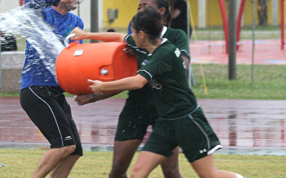 Kubasaki coach Christopher Eastman gets the water-bucket treatment from his players.
