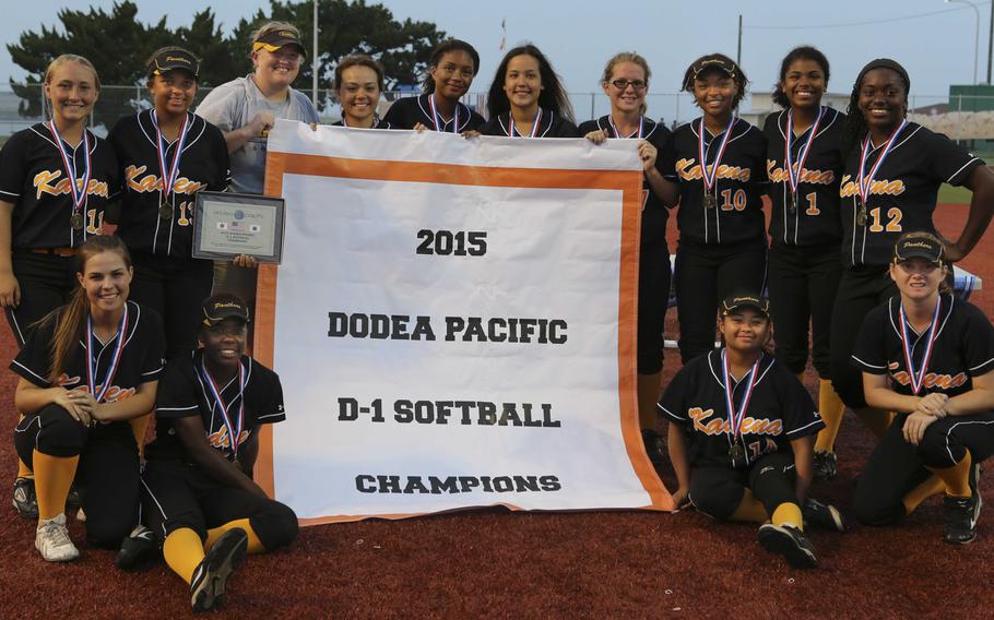 Back-to-back banners! Kadena softball team gathers around the symbol of the 2015 Far East D-I crown, their second in as many seasons.