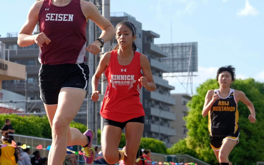 Seisen's Brittani Shappell leads Nile C. Kinnick's Arlene Avalos and ASIJ's Lisa Watanuki in the 1,600; she broke the Far East meet and her own Pacific record in the event.