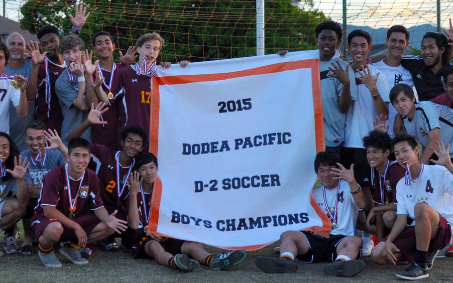 Perry players and coaches gather 'round the Far East Boys Division II soccer tournament banner that they've won for four straight years and for the fifth time in six.