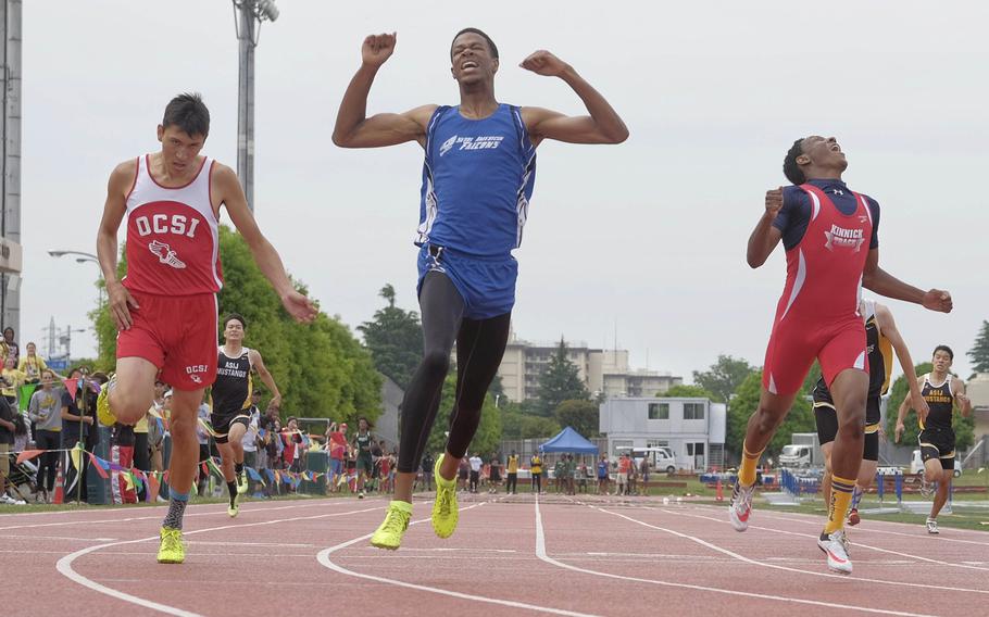 The thrill of victory and the agony of defeat. Seoul American's Shawn Horne exults as Okinawa Christian's Shawn Monroe and Nile C. Kinnick's Pacific record-holder Jabari Johnson hit the finish in the 400. The three finished .10 seconds apart and Horne set the meet record with a time of 49.06 seconds.