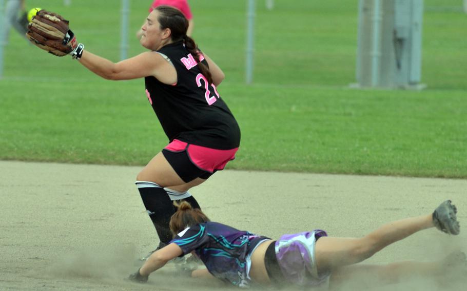 Okinawa Dragons baserunner Tiffany Carpenter beats the throw to Misfitz second baseman Diana Dalzell during the women's opening game in the 2015 Firecracker Shootout Softball Tournament. The two-time defending champion Dragons beat Misfitz 13-3.