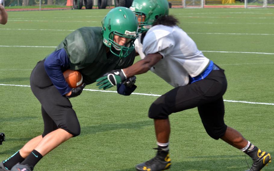 Daegu receiver Tommy Kazmierczak tries to avoid the tackle of teammate Jarvis Stokes during practice.