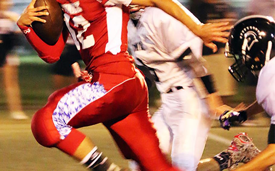 Nile C. Kinnick quarterback Kasey Walker takes off against Zama.