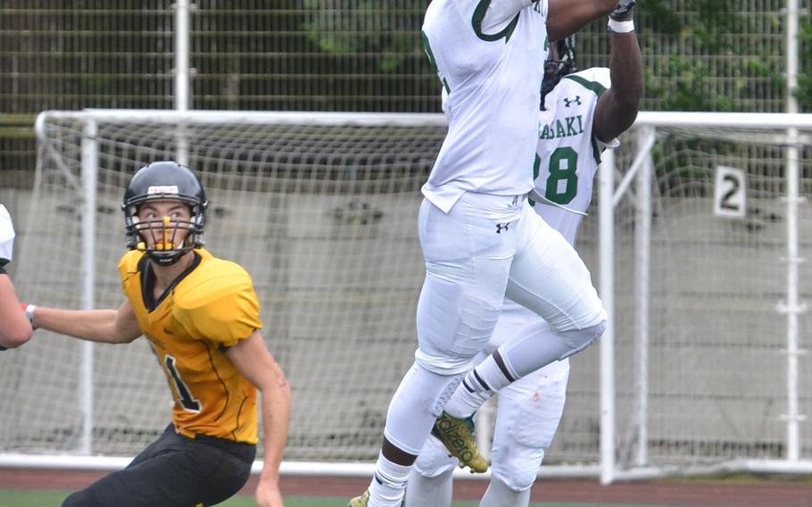 Kubasaki defensive back Isaiah Johnson leaps for one of his two interceptions against the American School In Japan.