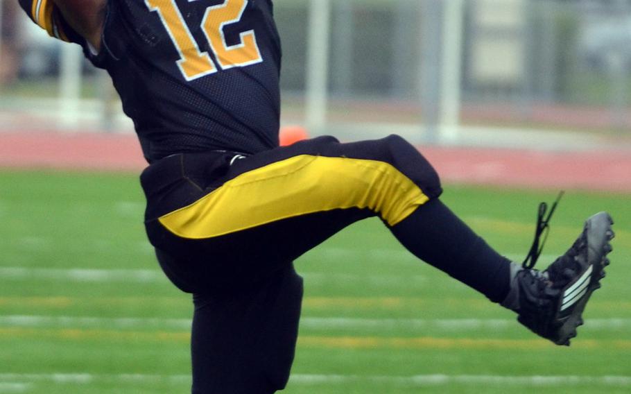 Kadena defensive back Keith Duenas skies to try to intercept a Nile C. Kinnick pass. The ball fell incomplete.