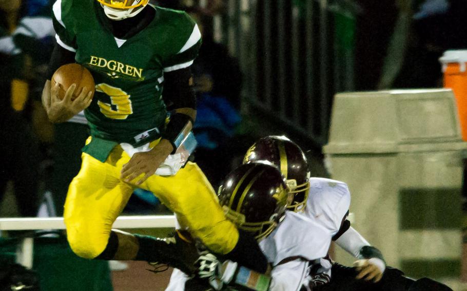 Robert D. Edgren QB Shawn Robinson-Ortiz gets dragged down by Matthew C. Perry defender Andrew Borrero.