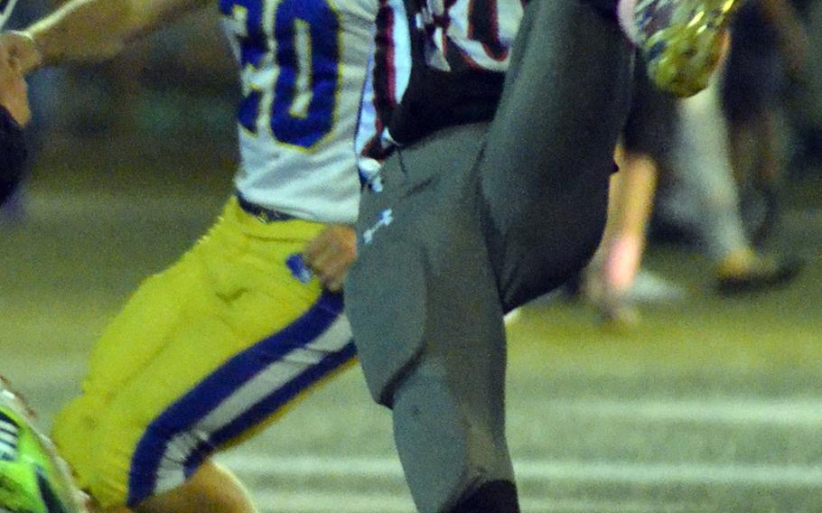 Nile C. Kinnick receiver Chauncey Jamerson snags a pass against Yokota defensive back Cole Grimes.