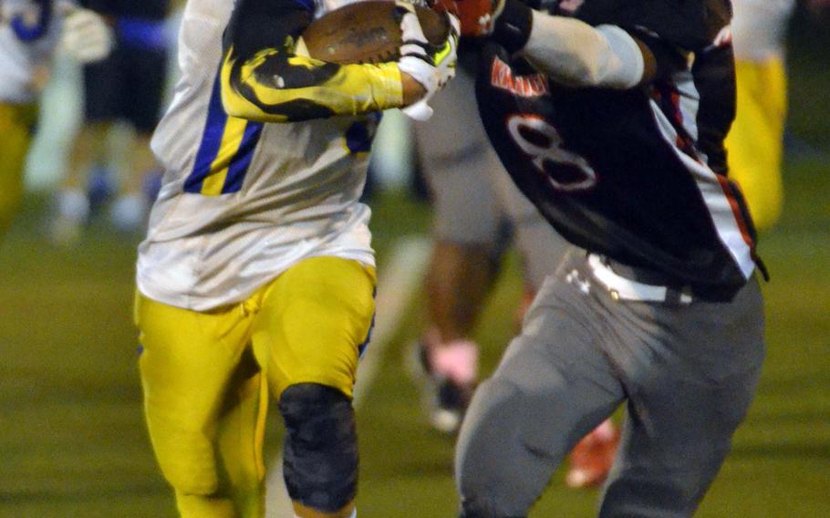 Yokota RB Shota Sprunger seeks running room against Nile C. Kinnick's Romeo Hall.