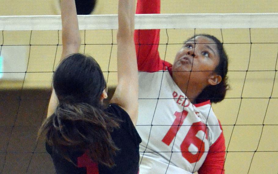 Nile C. Kinnick's Lexia Hall tries to spike past Seisen's Erin Barrett during Friday's play in the American School In Japan Yujo Invitational Volleyball Tournament. The Phoenix outlasted the Red Devils 25-17, 26-28, 19-17.