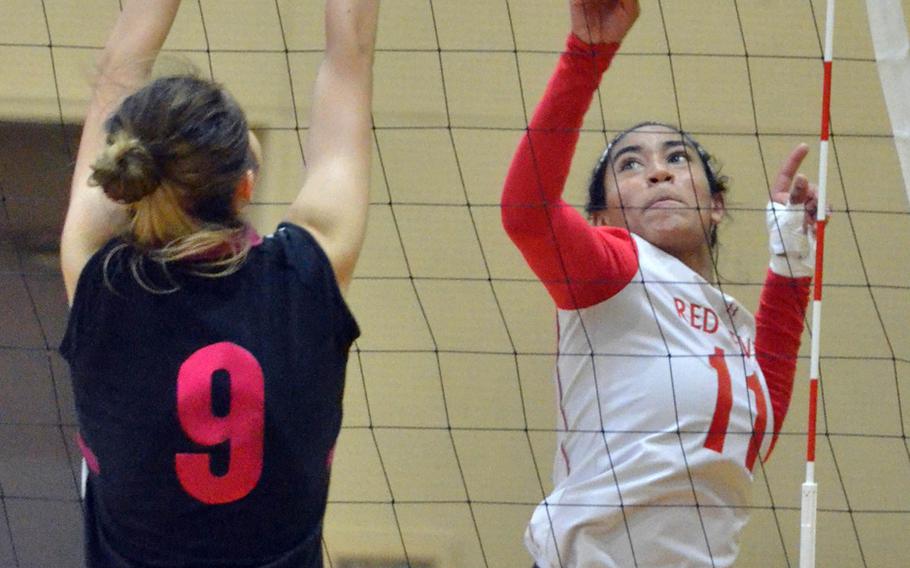 Nile C. Kinnick's Exotica Hall tries to spike past Seisen's Erin Barrett during Friday's play in the American School In Japan Yujo Invitational Volleyball Tournament. The Phoenix outlasted the Red Devils 25-17, 26-28, 19-17.