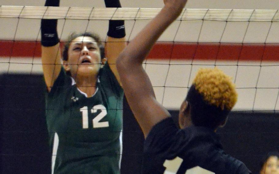 Zama's Saige Rivers tries to spike through the block of Robert D. Edgren's Isabel Tayag during Friday's DODDS Japan girls volleyball match. Edgren won in four sets, 25-18, 25-12, 20-25, 25-19.