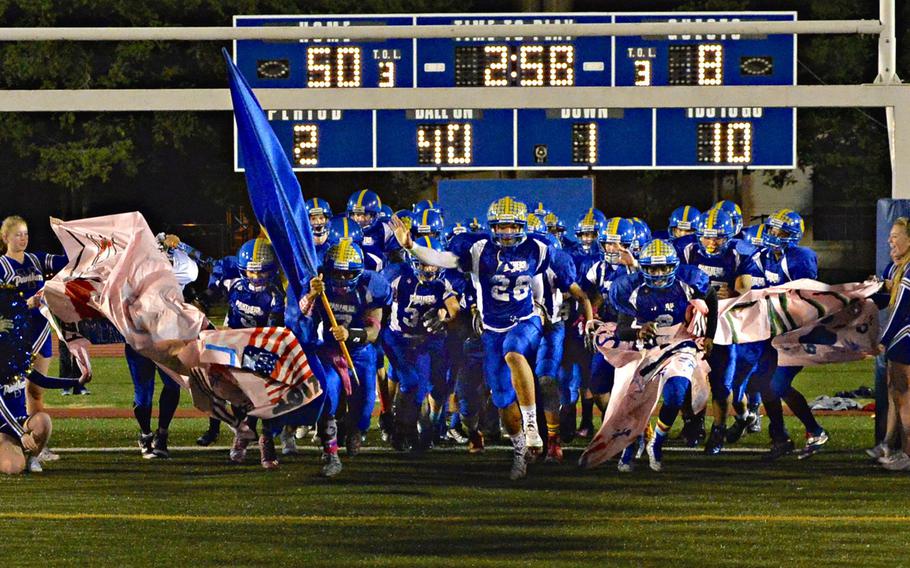 Yokota Panthers players burst onto the field to begin the second half of their 57-22 Homecoming win over Robert D. Edgren.