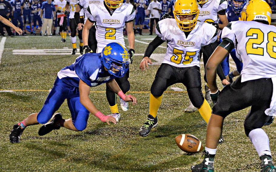 Yokota and Robert D. Edgren players surround a loose ball. The Panthers eventually recovered the fumble.