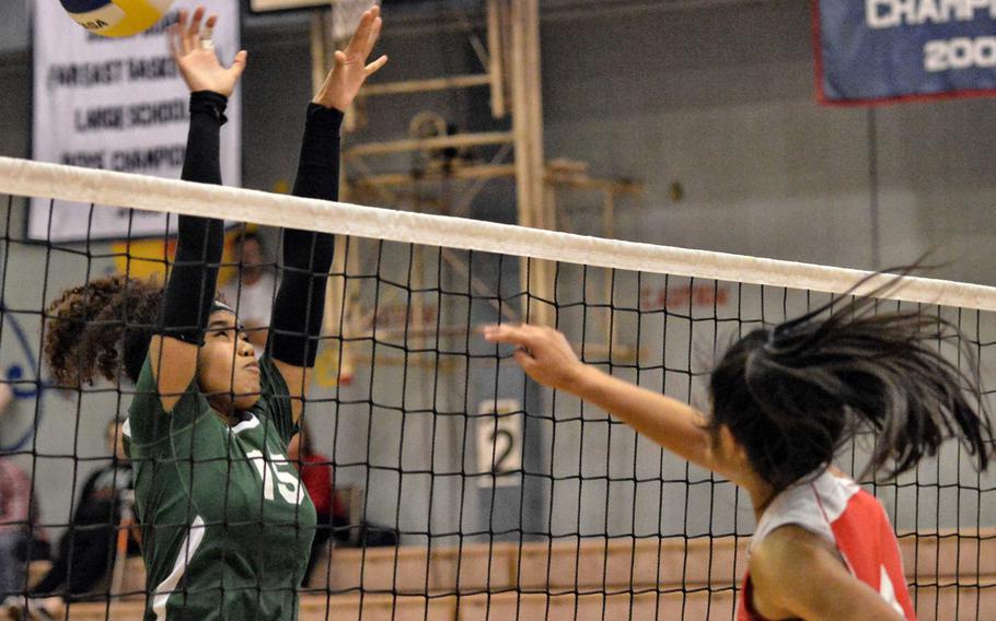 Nile C. Kinnick's Kiana Vicencio rifles a spike past Robert D. Edgren's Coko Magby. The Red Devils beat the Eagles in straight sets to advance to their ninth straight DODDS Japan volleyball tournament final.