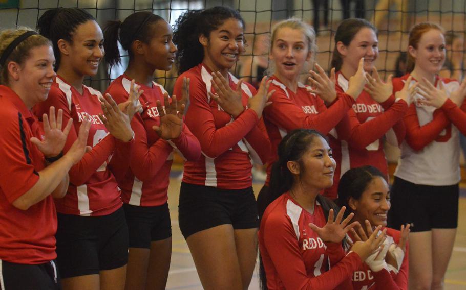 Nile C. Kinnick volleyball players cross their arms and hold up nine fingers, symbolic of the nine straight titles the Red Devils have won in the DODDS Japan volleyball tournament. Kinnick beat Matthew C. Perry in four sets in Saturday's final.