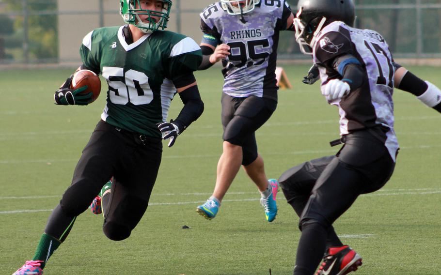 Daegu's Kenneth Musselwhite carries the ball against the defense of the Rhinos of Songdo, a Korean school in Inchon, just west of Seoul. The host Warriors, the two-time defending DODDS Korea and Far East Division II champions, beat the Rhinos 41-0.