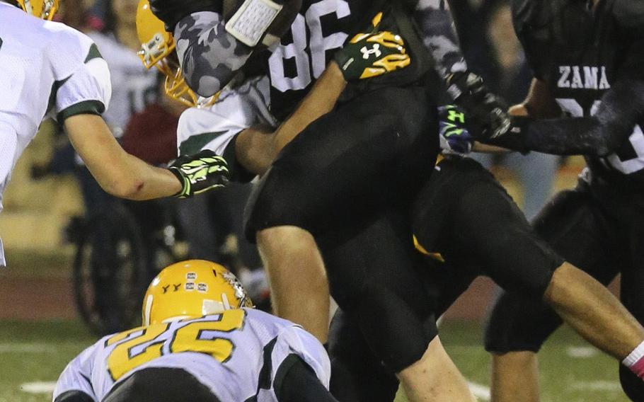 Zama TE Josh Atkinson leaps over Edgren defender Terrel Troxler.