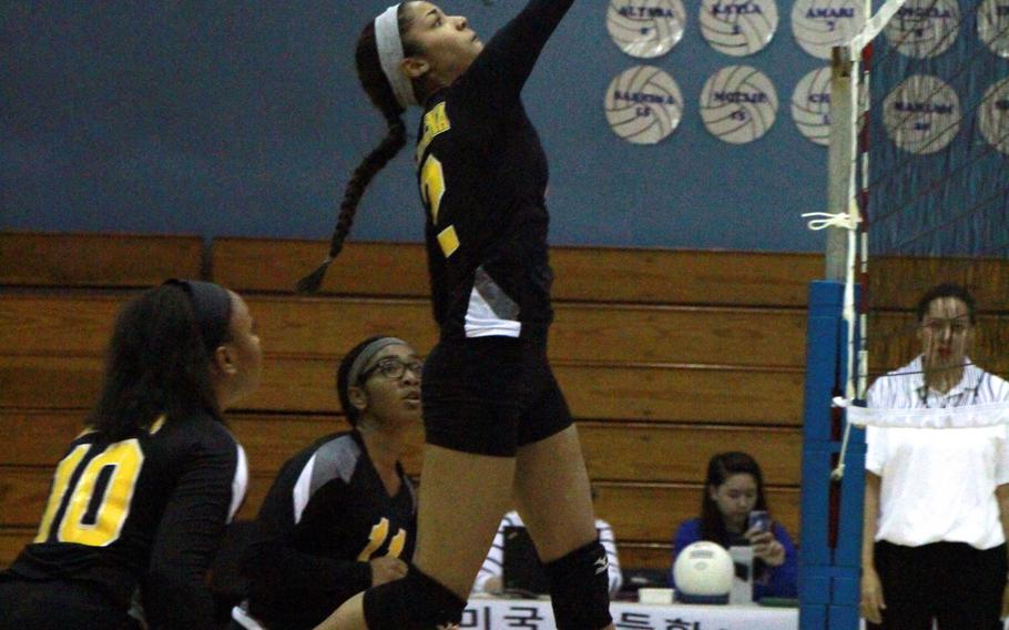 Kadena's Jaeda Flores goes up to hit the ball during Monday's round-robin play in the Far East Division I volleyball tournament. The Panthers split the four matches they played Monday.