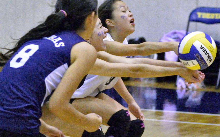 Sacred Heart's Lisa Sato, Mia Korver and Rina Ogawa make a play on the ball during Monday's pool-play match in the Far East HIgh School Division II volleyball tournament. The Symbas went 1-1 in pool play.