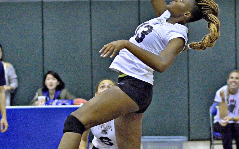Zama's Saige Rivers goes up to hit the ball during Tuesday's division-play match in the Far East High School Division II girls volleyball tournament. The Trojans won both their matches to capture the fourth seed going into the playoffs that start Wednesday.