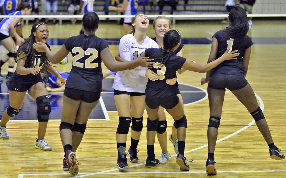Humphreys' players celebrate their victory over host Yokota following Wednesday's consolation playoff match in the Far East Division II volleyball tournament. The Blackhawks rallied past the host Panthers 17-25, 25-18, 25-17, 26-24.