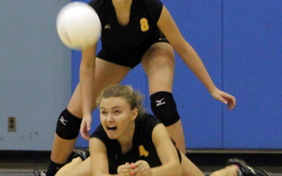 American School In Japan's Allie Rogers dives to receive serve in front of teammate Savannah Napierski during Thursday's championship match in the Far East Division I girls volleyball tournament. Defending champion Kubasaki made it two straight titles, beating the Mustangs in five sets.