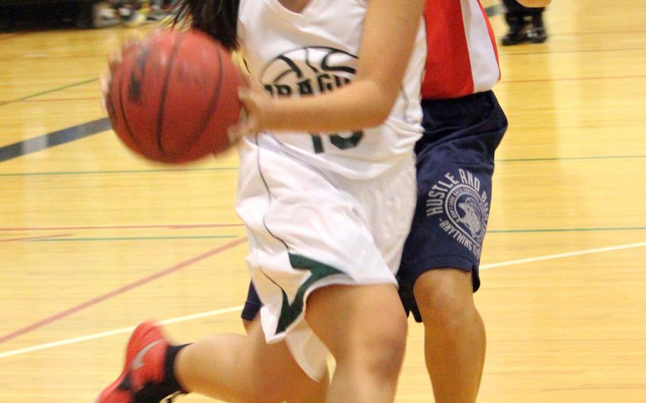 Kubasaki's Emelia Sacbayana drives to the basket against Futenma during Tuesday's season-opening game. The visiting Red Braves beat the Dragons 81-30.
