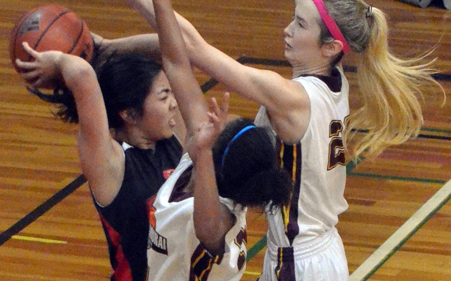 E.J. King's Gabby Hidalgo gets hemmed in by Matthew C. Perry defenders Devon Shuman and Naomi Ziola. The Samurai beat the Cobras 42-28 in the second game of the Sabres Invitational Girls Basketball Festival at Senri Osaka International School.