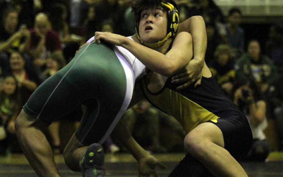 Kadena's Seth Crisp gets the early edge on Kubasaki's Eddie Carpiobran in the 115-pound bout of Tuesday's Okinawa district season-opening wrestling dual meet. Carpiobran rallied late for a pinfall victory in 5 minutes, 58 seconds, but the Panthers outlasted the Dragons 33-29.