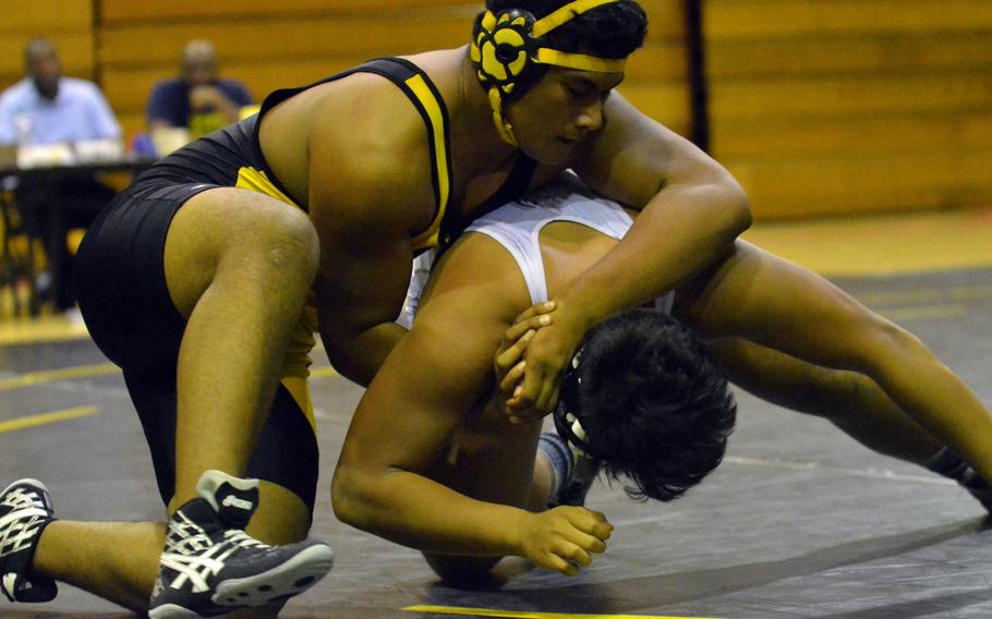 Kadena's Siulagisipai Fuimaono goes to work early on Kubasaki's Caleb Sablan in the 275-pound bout of Tuesday's Okinawa district season-opening wrestling dual meet. Fuimaono pinned Sablan in 2 minutes, 11 seconds, and the Panthers outlasted the Dragons 32-29.