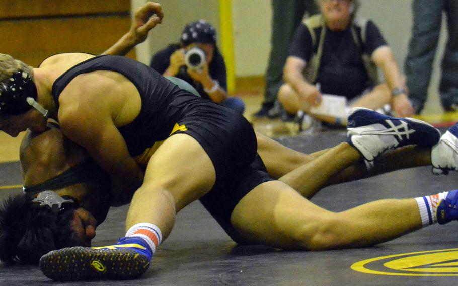 Kadena's Parker Corwin gets the upper hand on Kubasaki's Josh Figueredo in the 135-pound bout of Tuesday's Okinawa district season-opening wrestling dual meet. Corwin pinned Figueredo in 2 minutes, 20 seconds and the Panthers outlasted the Dragons 33-29.
