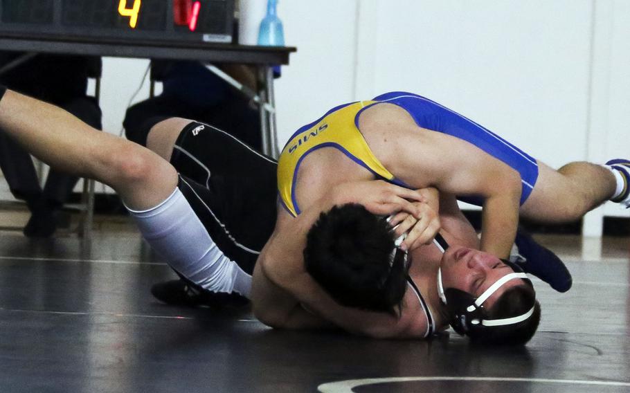 Yokota's Sam Michelsen gets the upper hand on Zama's Sam Preston in a 180-pound bout during the ZamaDuels wrestling tournament. Nile C. Kinnick won the tournament, its second title in successive weeks.

