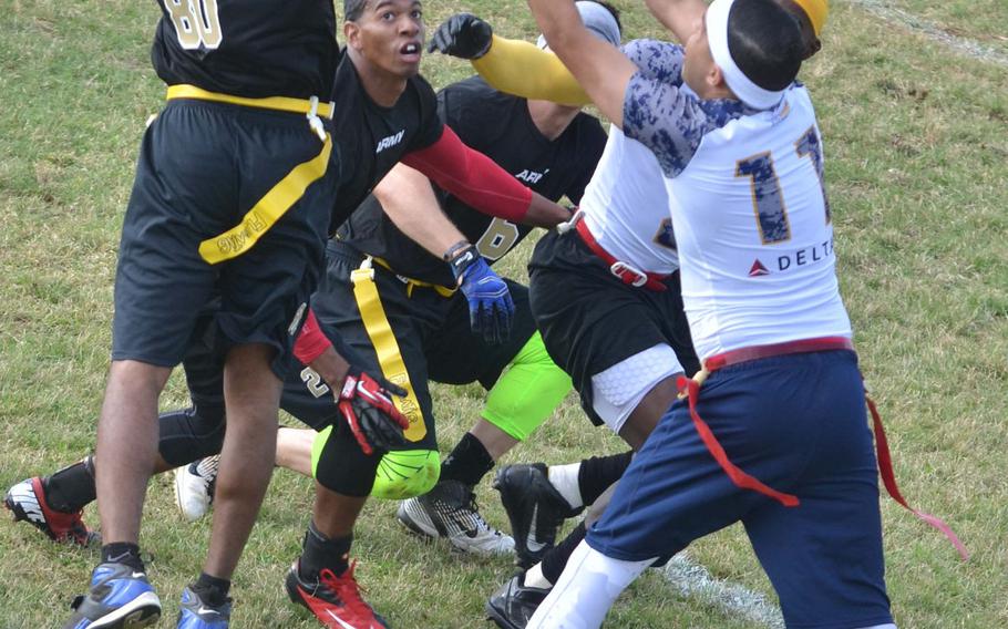 Army's Rodney Simmons goes up against a sea of soldiers and sailors to snag an interception during a flag-football game Saturday at Torii Station, Okinawa.
