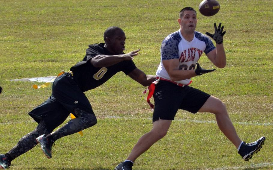 Navy's Gregg Nieten catches a touchdown pass in front of Army's Brandon Miller during a flag-football game Saturday at Torii Station, Okinawa.