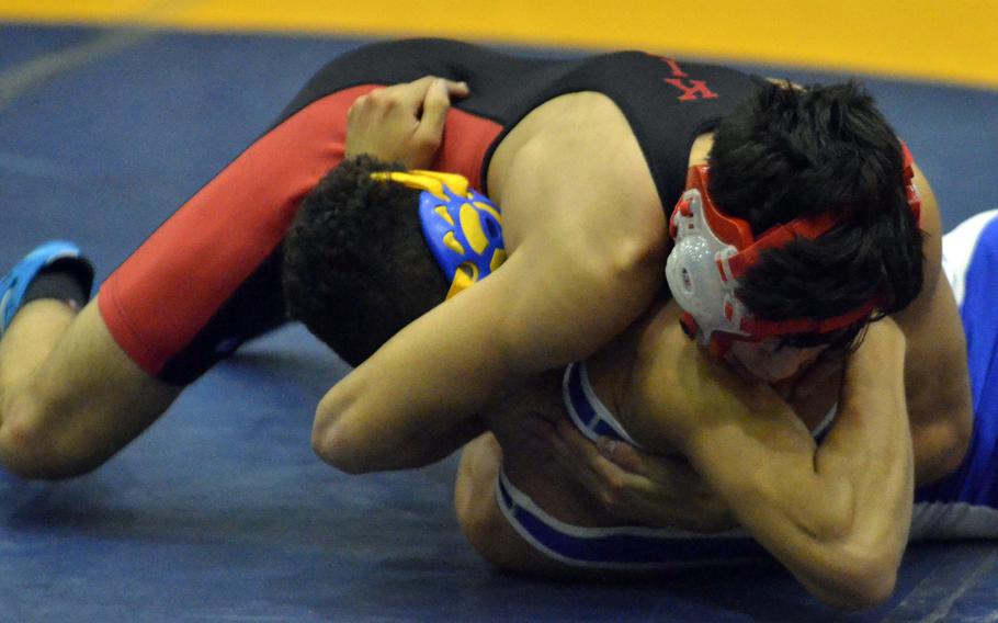 Nile C. Kinnick's Vincent Soiles finishes off Yokota's Bryce Delafosse in the 129-pound bout during Wednesday's Kanto Plain wrestling dual meet. Soiles pinned Delafosse in 2 minutes, 35 seconds and the Red Devils won the meet 46-14.