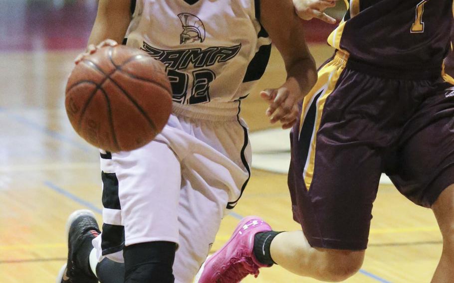 Zama's Ti'Ara Carroll drives against Perry's Lebet Erhart during Friday's girls basketball game, won by the Trojans 43-24.