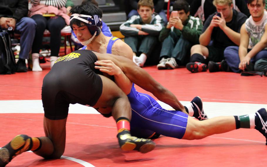St. Mary's Kazuho Kawashima and Kadena's Jason Bland grapple for the edge in the 148-pound first-place bout in the "Beast of the Far East" Wrestling Tournament. Kawashima won by technical fall.