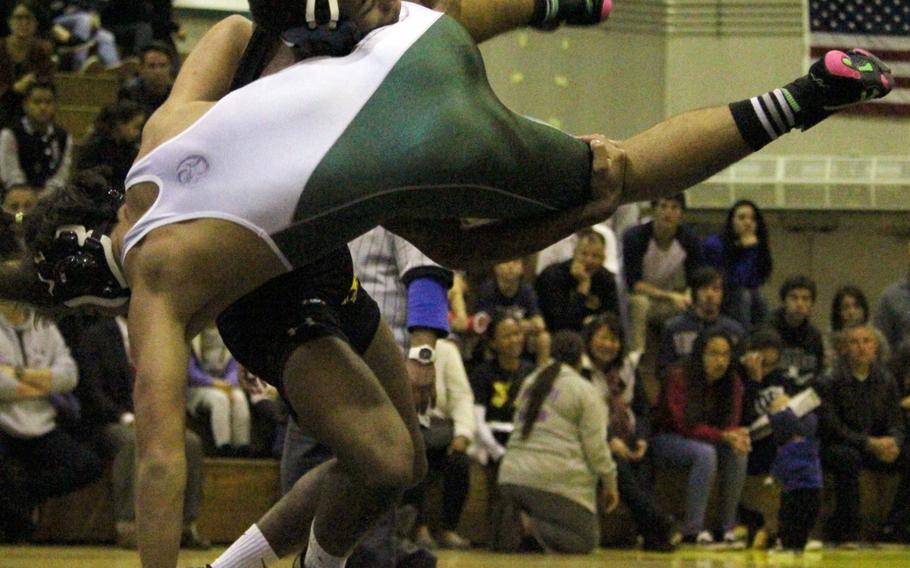 Kadena's Jason Bland sends Kubasaki's Jonathan Orr airborne in the 158-pound bout during Wednesday's Okinawa dual meet, won by the Panthers 46-16. Bland pinned Orr in 4 minutes, 20 seconds.