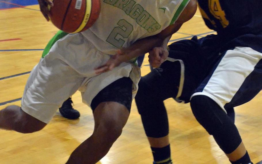 Kubasaki's Jacob Green plows into a Taipei American defender as the Dragons beat the host Tigers 82-69 Saturday to complete their sweep of three games in the weekend basketball exchange.