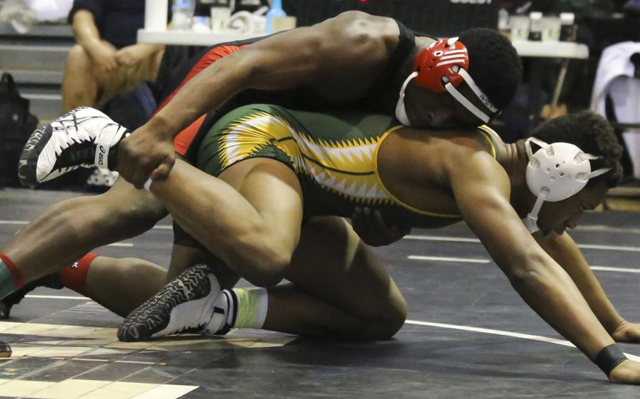 Nile C. Kinnick's Dwayne Lyon gains control of Robert D. Edgren's Patrick Sledge in the 180-pound first-place bout of Saturday's Yokota Invitational Wrestling Tournament at Zama. Lyon won 4-4 by scoring the last point.