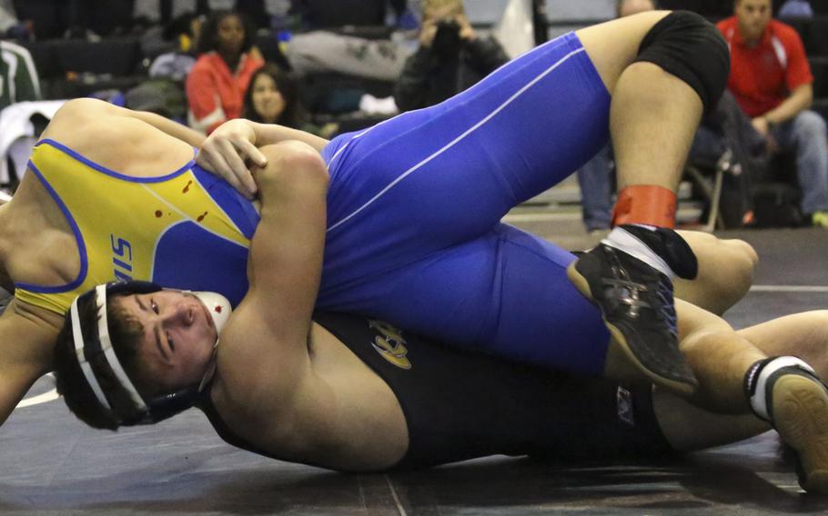 Kadena's Hunter Corwin gut-wrenches St. Mary's Austin Koslow for a two-point tilt in the 158-pound first-place bout of Saturday's Yokota Invitational Wrestling Tournament at Zama. Corwin won by technical fall 12-2 in 2 minutes, 15 seconds.