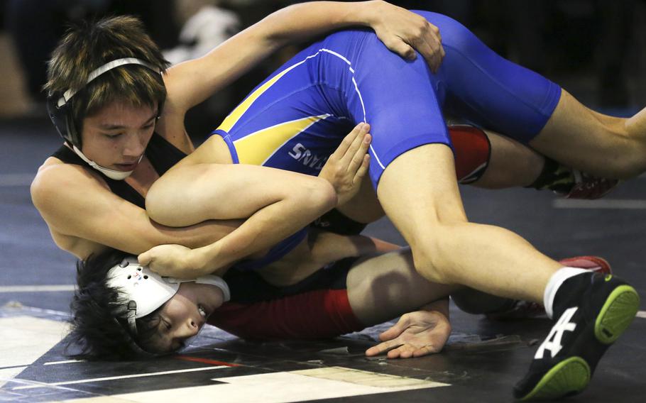 Nile C. Kinnick's Lucas Wirth, a reigning Far East champion, gets the upper hand on Tatsuhito Matsumoto of St. Mary's in the 108-pound title bout of Saturday's Yokota Invitational Wrestling Tournament at Zama. Wirth won by technical fall 10-0 in 5 minutes, 42 seconds.