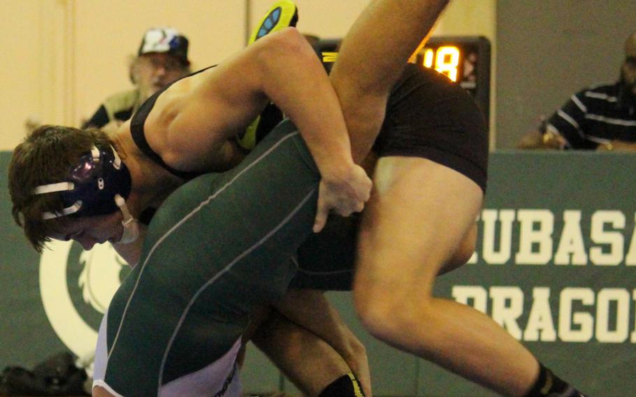 Kadena's Hunter Corwin tries to twist Kubasaki's Jonathan Orr's shoulders toward the mat in the 158-pound bout during Wednesday's regular season-ending dual meet. Corwin won by technical fall 11-0 in 4 minutes, 3 seconds, and the Panthers rallied from 28-6 down to edge the Dragons 33-29 to win the meet.