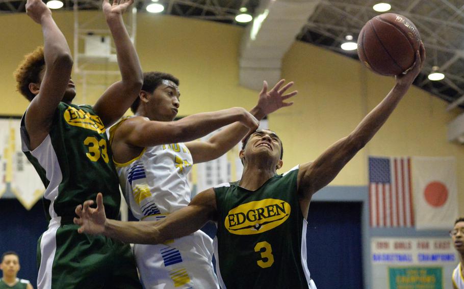 Edgren's Shawn Robinson-Ortiz tries to control the ball against Yokota's Jam Harvey during Friday's semifinal game in the DODDS Japan basketball tournament. The Panthers won 60-56 and will meet Kinnick for the title on Saturday.
