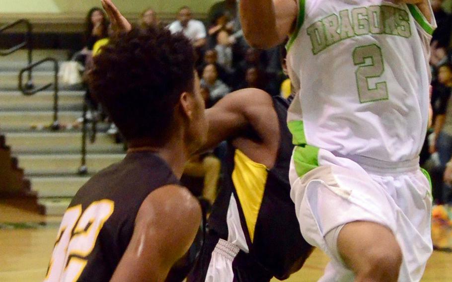 Kubasaki's Jacob Green drives to the basket against Kadena during Friday's boys basketball game, won by the Dragons 67-49. Kubasaki completed a regular-season sweep of the Panthers with the win.