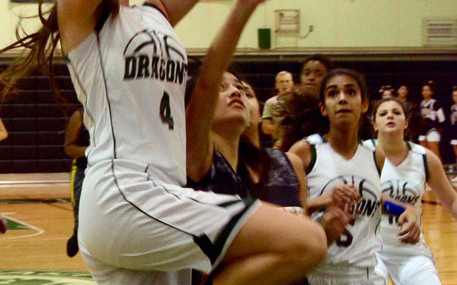 Kubasaki's Chloe' Stevens drives to the basket against Kadena during Friday's girls basketball game, won by the Panthers 44-31. Kadena completed a regular-season sweep of the Dragons with the win.