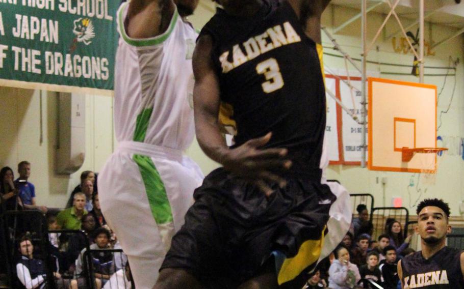 Kadena's Isaiah Richardson takes it to the rack against Kubasaki's Matt Ashley during Friday's boys basketball game, won by the Dragons 67-49. Kubasaki completed a regular-season sweep of the Panthers with the win.