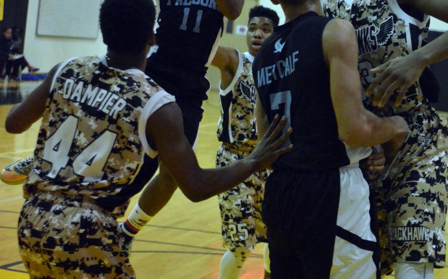 Seoul American's M.J. Haynes shoots over teammates and Humphreys opponents during Saturday's 54-50 win in the Korea Blue Division tournament final.